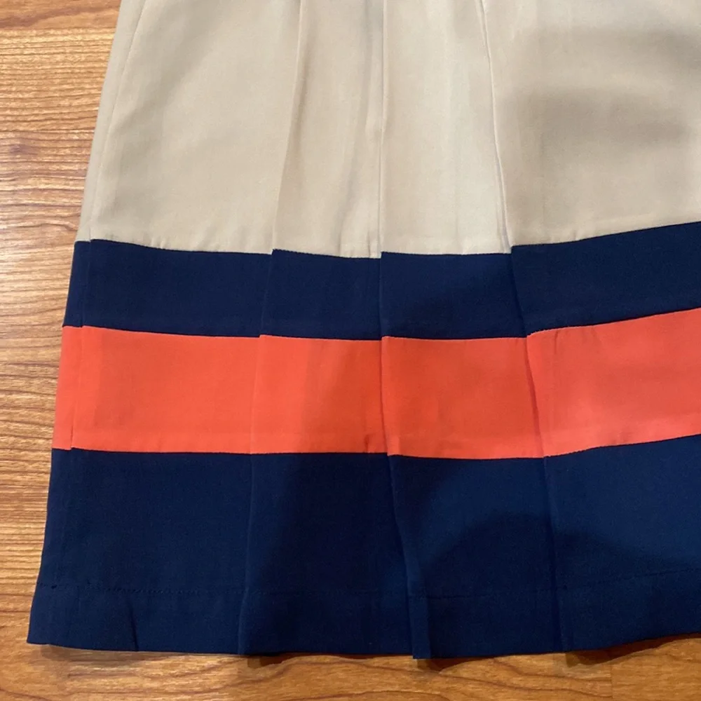 Very soft lined skirt with three pleads on the side. Size 4